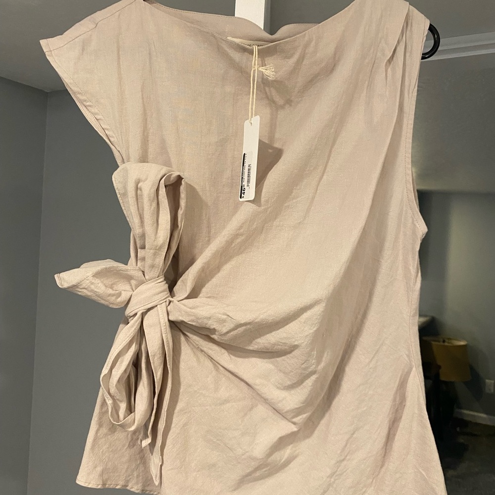 Cute linen top, asymmetrical with side tie. Color is tan.
